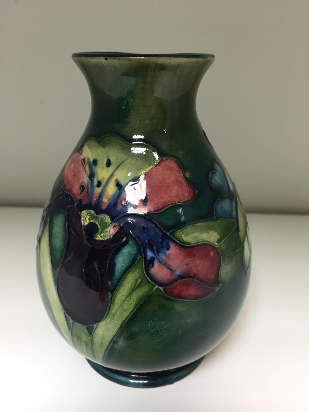 A Moorcroft Orchid pattern vase, the baluster form decorated to a green ground, impressed marks - Image 2 of 2