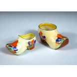 Two Clarice Cliff crocus pattern clogs, each painted in colours, printed marks, the larger 13cm long