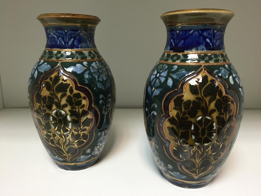 A pair of small Doulton Lambeth Slater patent vases, of baluster form with foliate decorated