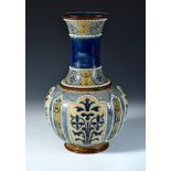 A Doulton Lambeth stoneware vase by George H. Tabor, the bottle form with incised and applied