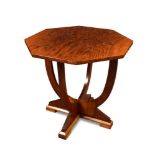 An Art Deco walnut lamp table, the octagonal top supported on twin U-shaped base and stepped feet,