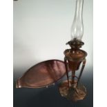 A Birmingham Guild of Handicraft copper oil lamp, the lamp supported on three elongated shaped