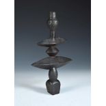 A cast iron candlestick, cast after a design by Diego Giacometti, signed to base 33½cm (13in)