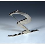 A silvered bronze model of a stylised skier after the original by Hagenauer, modelled in a