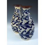 A pair of Doulton Lambeth stoneware vases by George Tinworth, each of baluster form with incised and