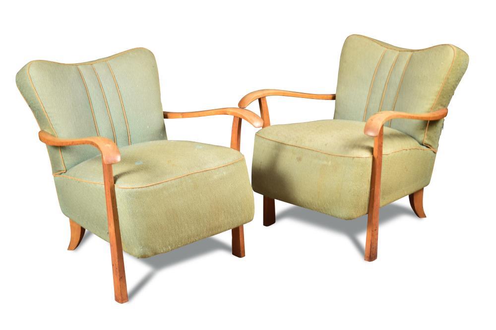 A pair of Art Deco open armchairs, the shaped backs and over stuffed seats in pale green fabric