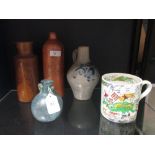 The Husbandsman Diligence Provides Bread' mug and other stoneware and a Roman style blue glass
