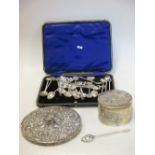 An early 20th century Chinese silver circular trinket box, repousse decorated with flowers, 4.9oz,