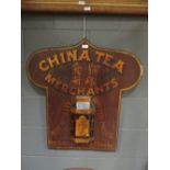 A wooden sign for China Tea Merchants, Bristol and London, with a shaped top, 77 x 73 cm