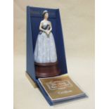 A Royal Doulton model of Queen Elizabeth II, cased with certificate. Figure 20cm