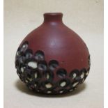 A small Poole stoneware vase by Guy Sydenham, with carved and glazed repeated circular patterns,