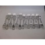 A set of six Old English pattern silver table forks, and a matching set of eight side forks,