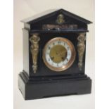 A black slate and marble inlaid mantle clock