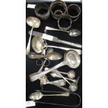 A collection of various silver and plated items to include napkin rings, ladles etc