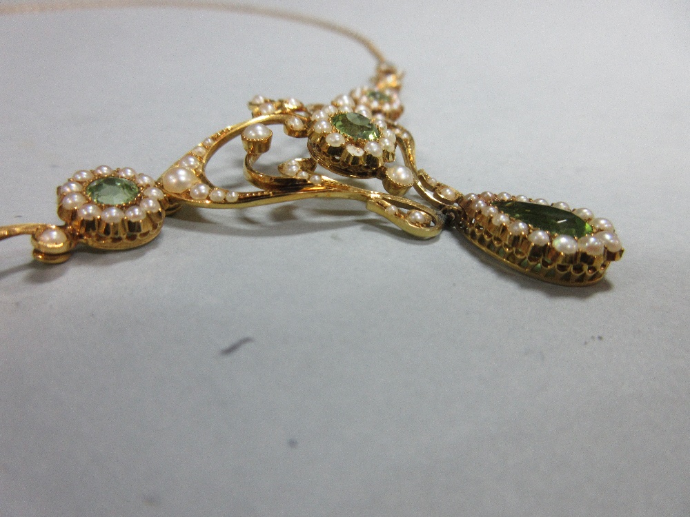 An Edwardian peridot and pearl necklace, the central art nouveau style motif set with a round cut - Image 3 of 7