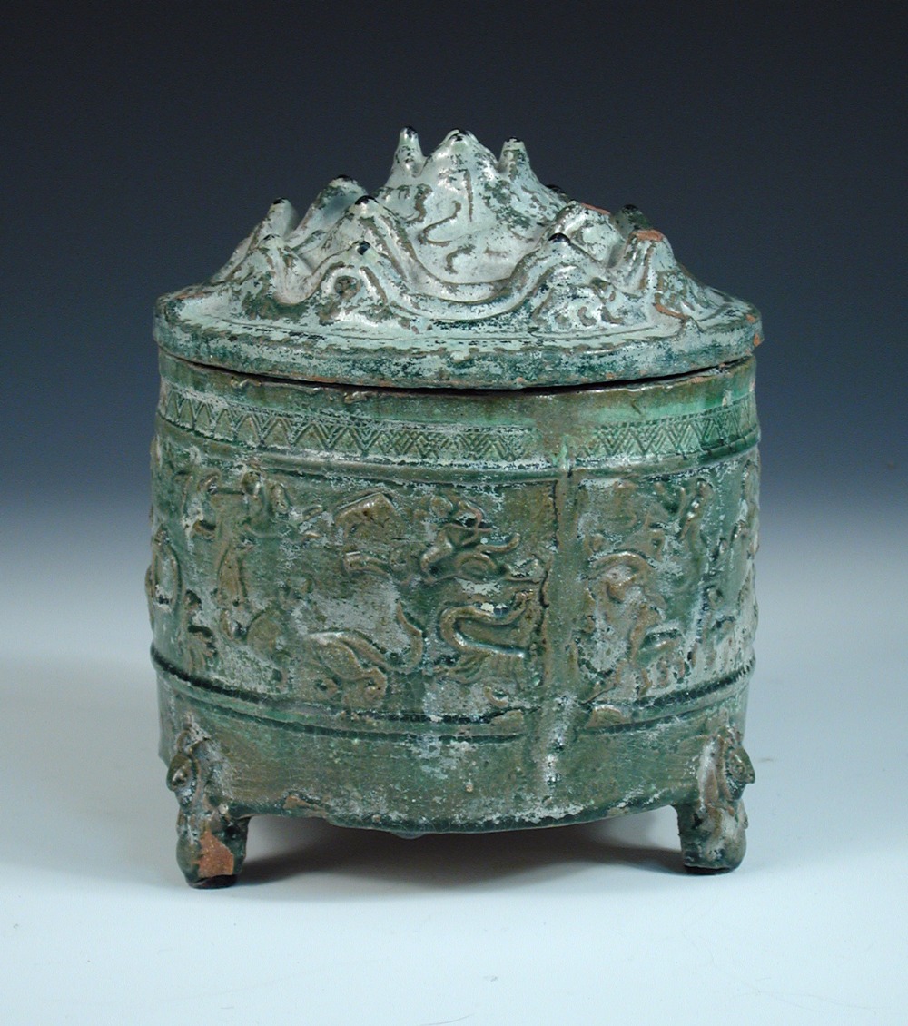 A Han dynasty green glazed jar and mountain cover (boshanlu), the mountain modelled cover resting on