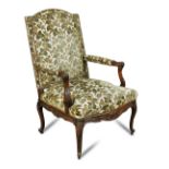 A George II style mahogany Gainsborough chair, circa 1900, carved show wood to the arms and frame,
