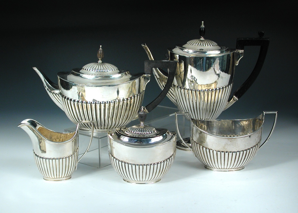 A matched mainly Victorian five piece silver tea set, principally by Edward Hutton, London 1890 &