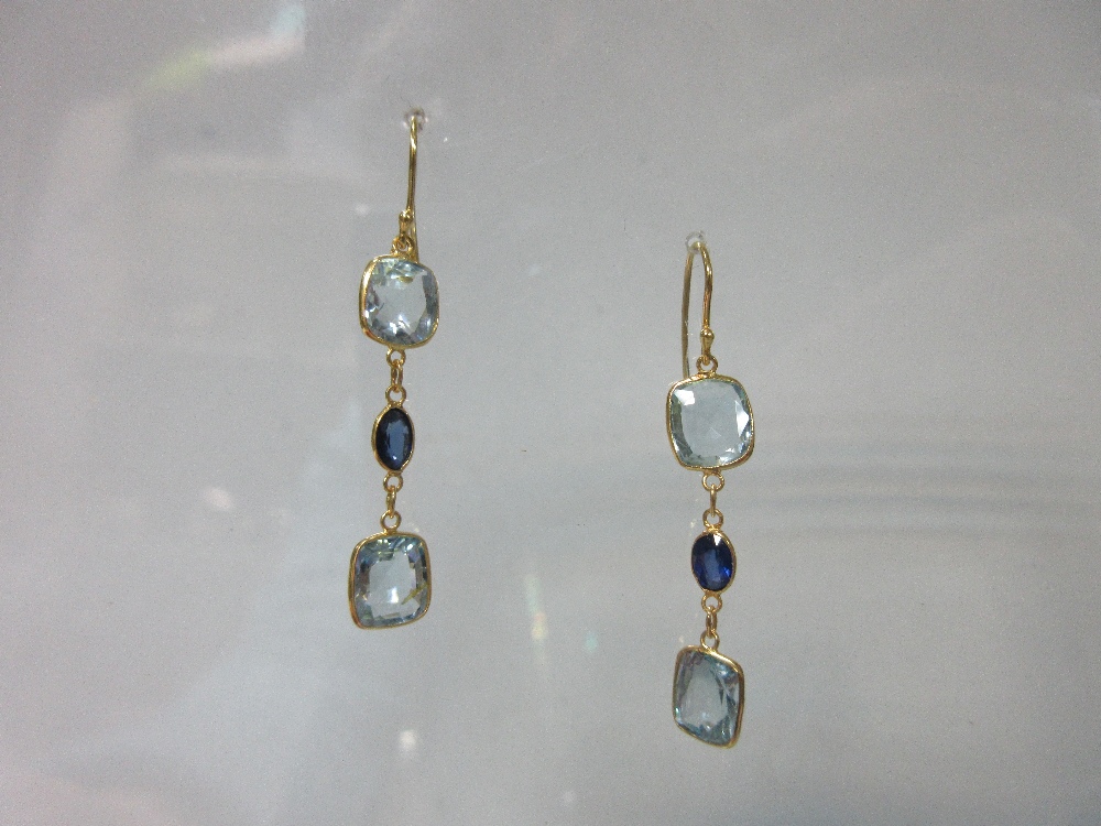 A pair of aquamarine and sapphire earpendants, each wire hook suspending an articulated line of