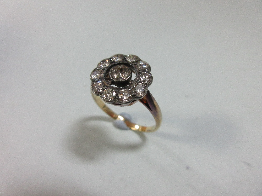 A diamond pierced cluster ring, with a central millegrain collet set round brilliant cut diamond - Image 2 of 7