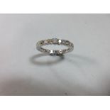 A full hoop diamond eternity ring, the round brilliant cut diamonds alternating slightly larger