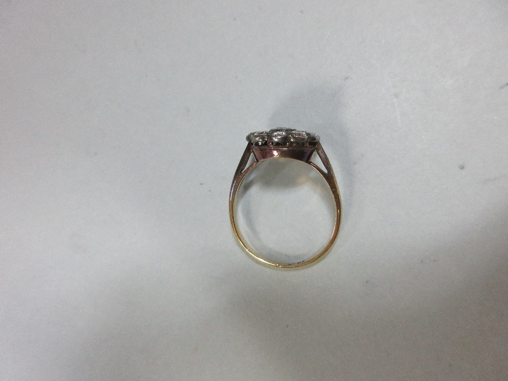 A diamond pierced cluster ring, with a central millegrain collet set round brilliant cut diamond - Image 6 of 7