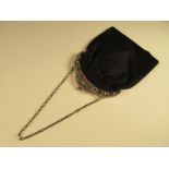 A vintage evening bag with gemset clasp, the hinged triple arched and pierced clasp of white