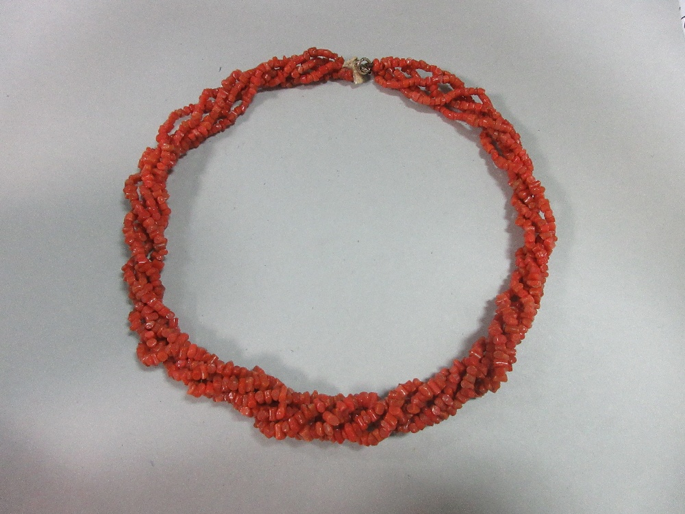 A vintage five strand coral bead necklace, each bead a short length of branch coral, graduated in