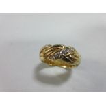 An 18ct gold and diamond band ring, of ropetwist design alternating reeded bands with lines of