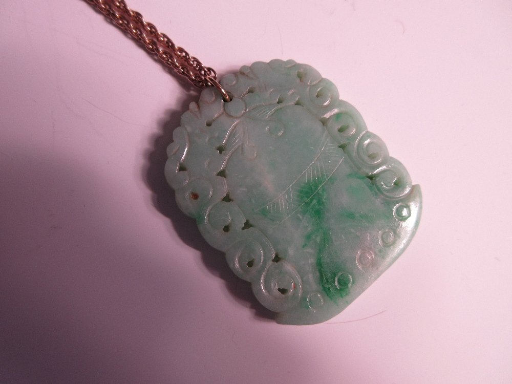 A carved jadeite jade pendant on a ropetwist chain, the mottled light green jade plaque carved on - Image 2 of 4