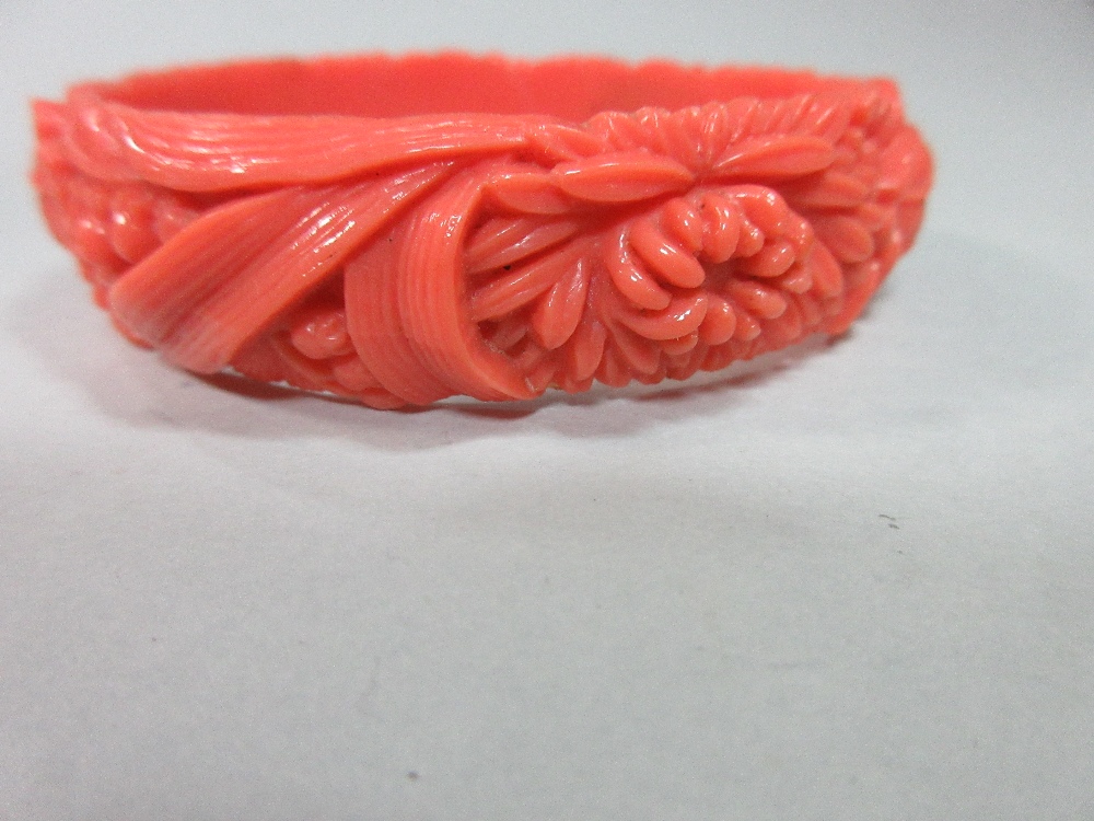 A graduated strand of coral beads and an early plastic carved 'coral' bangle, the necklace of - Image 3 of 7