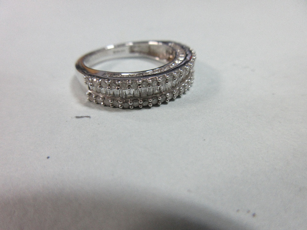 A diamond and white gold half band ring, with a channel set line of baguette cut diamonds between - Image 4 of 4