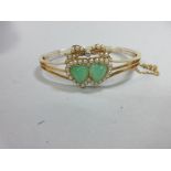 A double heart chrysoprase, seed pearl and diamond hinged bangle, the two heart-shaped cabochons