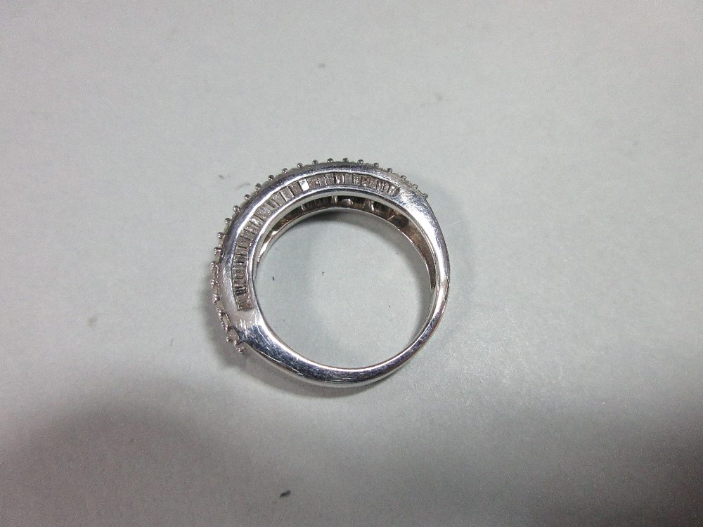 A diamond and white gold half band ring, with a channel set line of baguette cut diamonds between - Image 2 of 4