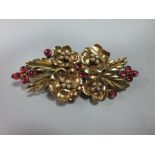 A mid 20th century flower spray double clip brooch set with pink sapphires and seed pearls, the