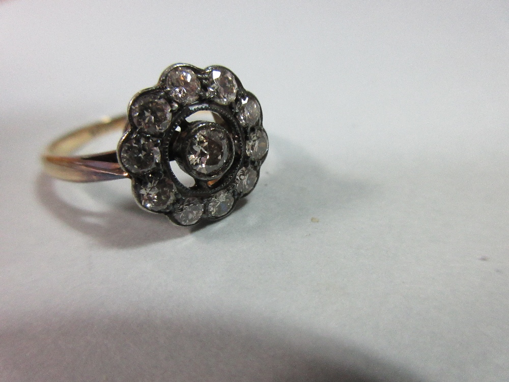 A diamond pierced cluster ring, with a central millegrain collet set round brilliant cut diamond - Image 7 of 7