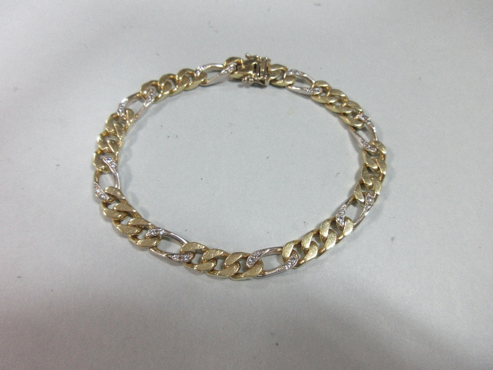 An 18ct bi-coloured gold and diamond set bracelet, the flattened curb link bracelet with every