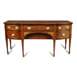 A George III mahogany breakfront sideboard, with bow ends, crossbanded in satinwood, central drawer,