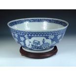 A Canton blue and white bowl, the exterior painted with four reserves of vases on a ground of cherry