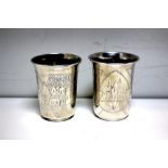 Two Russian silver beakers of tapering cylindrical form, each with foliate and architectural