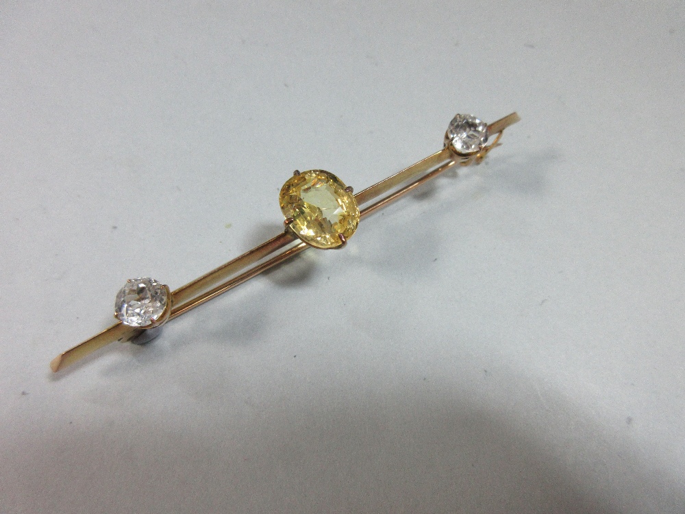 A yellow sapphire and white sapphire bar brooch, claw set to the centre of the knife-edge bar with - Image 2 of 6