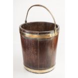A George III mahogany and brass bound peat bucket, 59 x 40cm (23 x 16in)  The bucket is sound with