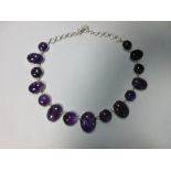 A modern amethyst rivière necklace, composed of graduated alternating oval and round cabochon