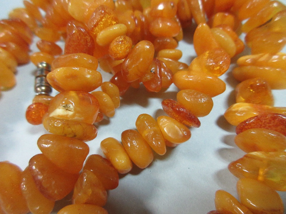 A butterscotch amber bead necklace, of graduated randomly shaped 'pebble' beads, gross weight 41.8g, - Image 4 of 4