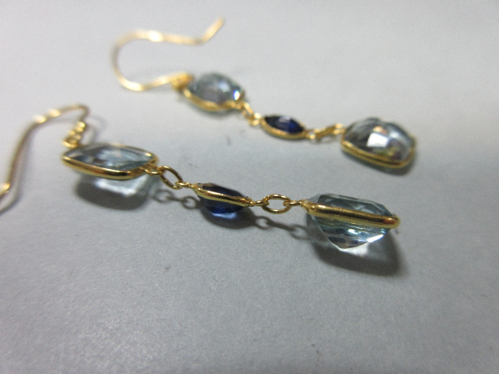 A pair of aquamarine and sapphire earpendants, each wire hook suspending an articulated line of - Image 2 of 2