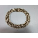 A 9ct gold fancy twist link bracelet, each link an open figure of eight, alternating plain