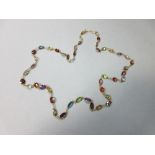 A multi-gemset chain necklace, spectacle set all along with graduated oval and round cut stones,