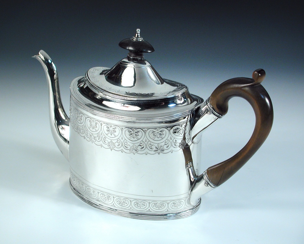 A George III silver teapot, by Peter and Ann Bateman, London 1799, the oval body with two bands of