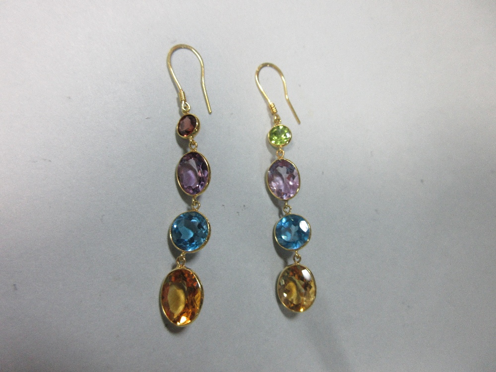 A pair of multi-gemset earpendants, each yellow precious metal wire hook suspending a graduated line