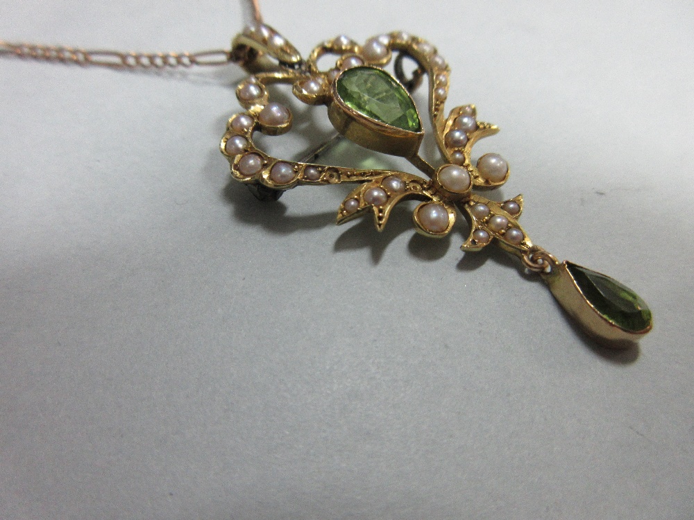 An Edwardian peridot and seed pearl pendant/brooch with chain, the open heart-shaped pendant with - Image 2 of 3